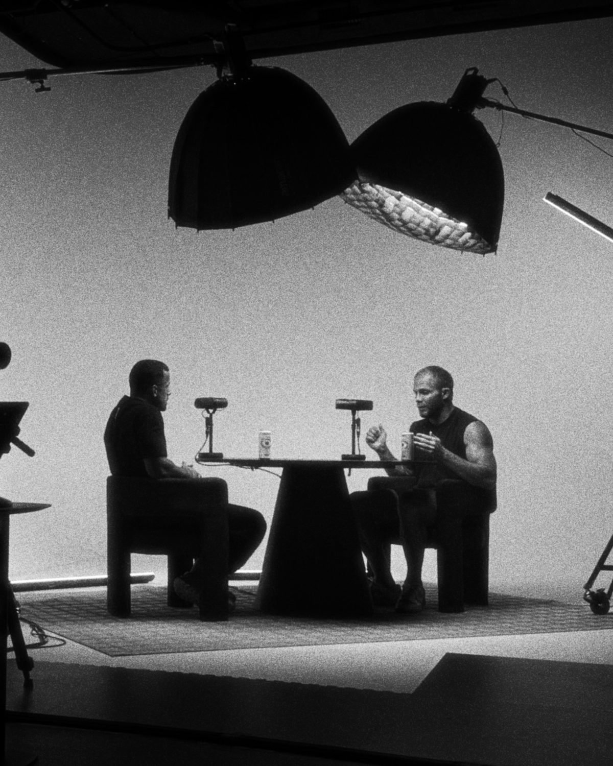 On set: two guests in conversation under the softboxes.